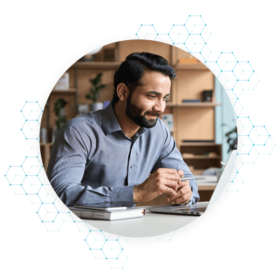 Smiling Man Using Laptop Computer in an Office