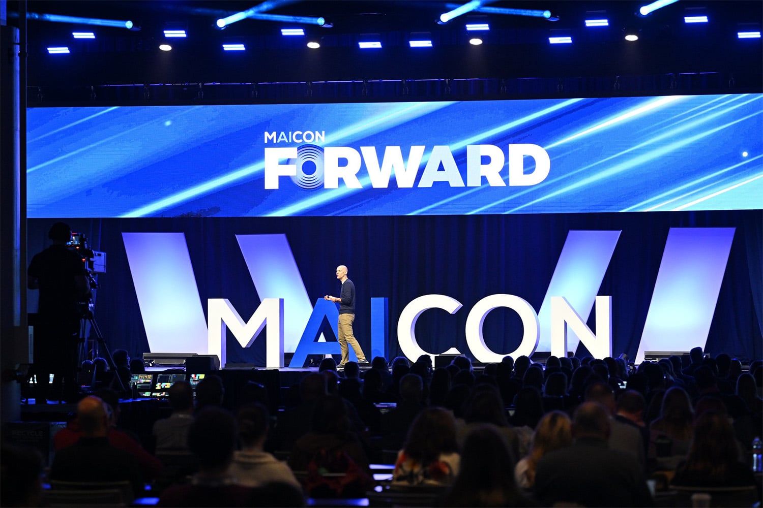 MAICON 2026 conference presentation with speaker and audience
